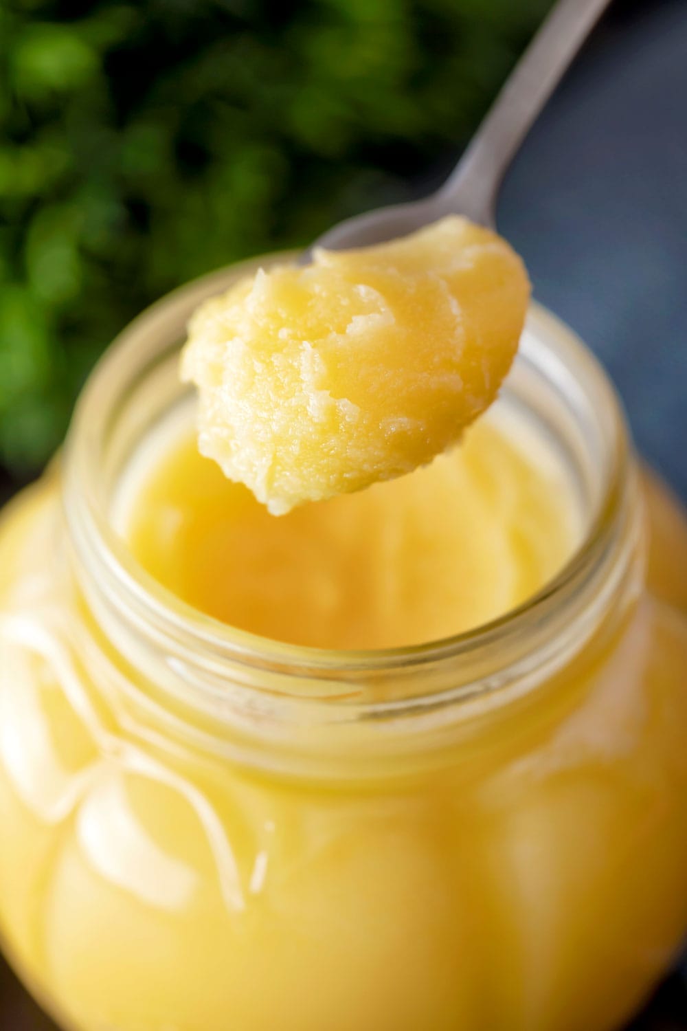 Spoon of pure cow ghee over the jar